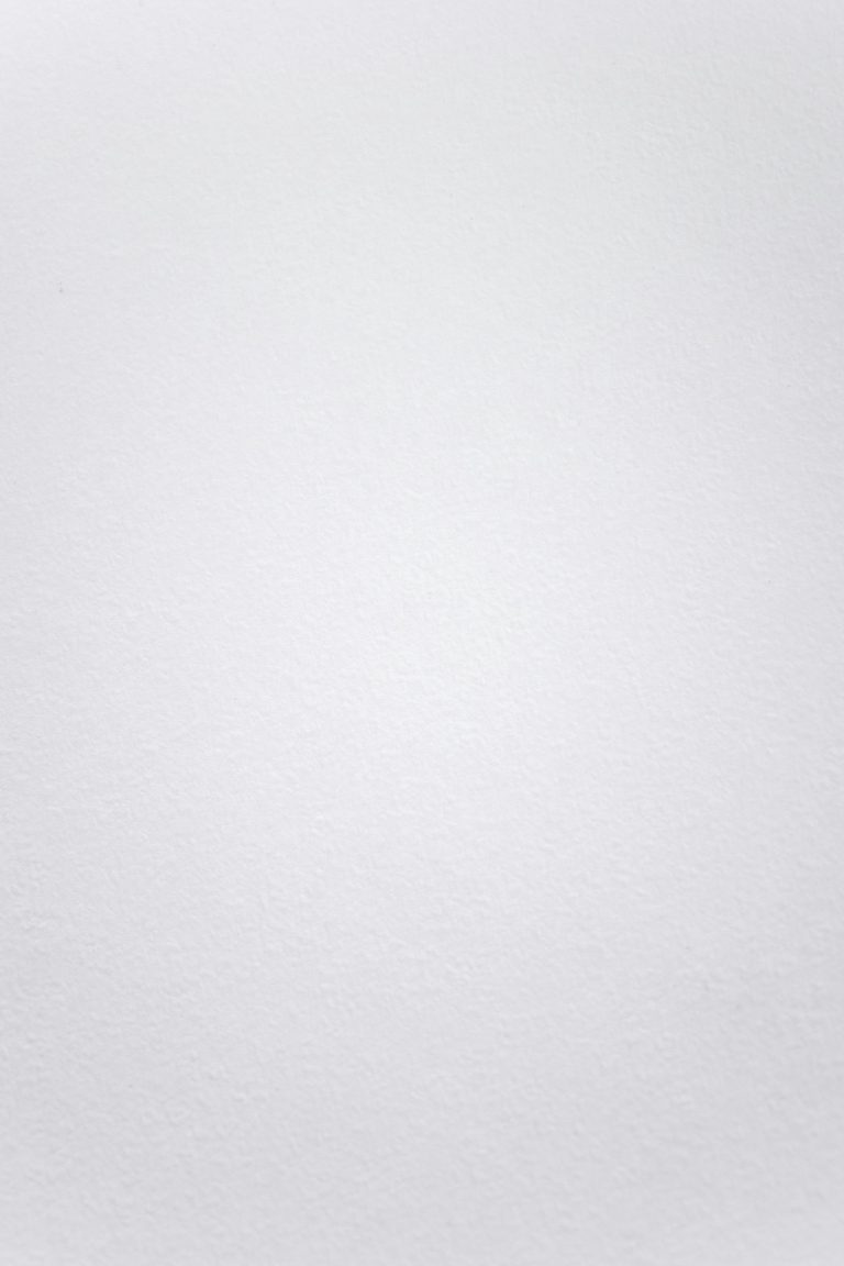 A smooth white textured background suitable for minimalistic design projects.